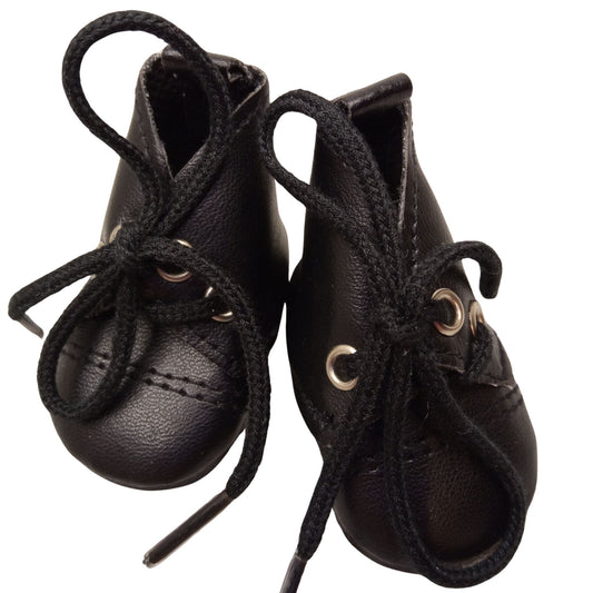 Sleek black lace-up boots for 32 cm Paola Reina dolls with matching black laces and sturdy soles, perfect for stylish and adventurous outfits.