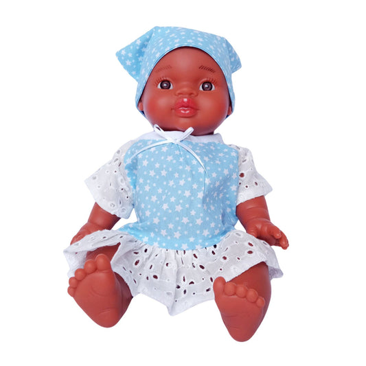 Dark-skinned baby doll wearing a blue star-print cotton dress with white eyelet lace and a matching kerchief, made for 34 cm dolls like Paola Reina and Baby Born.