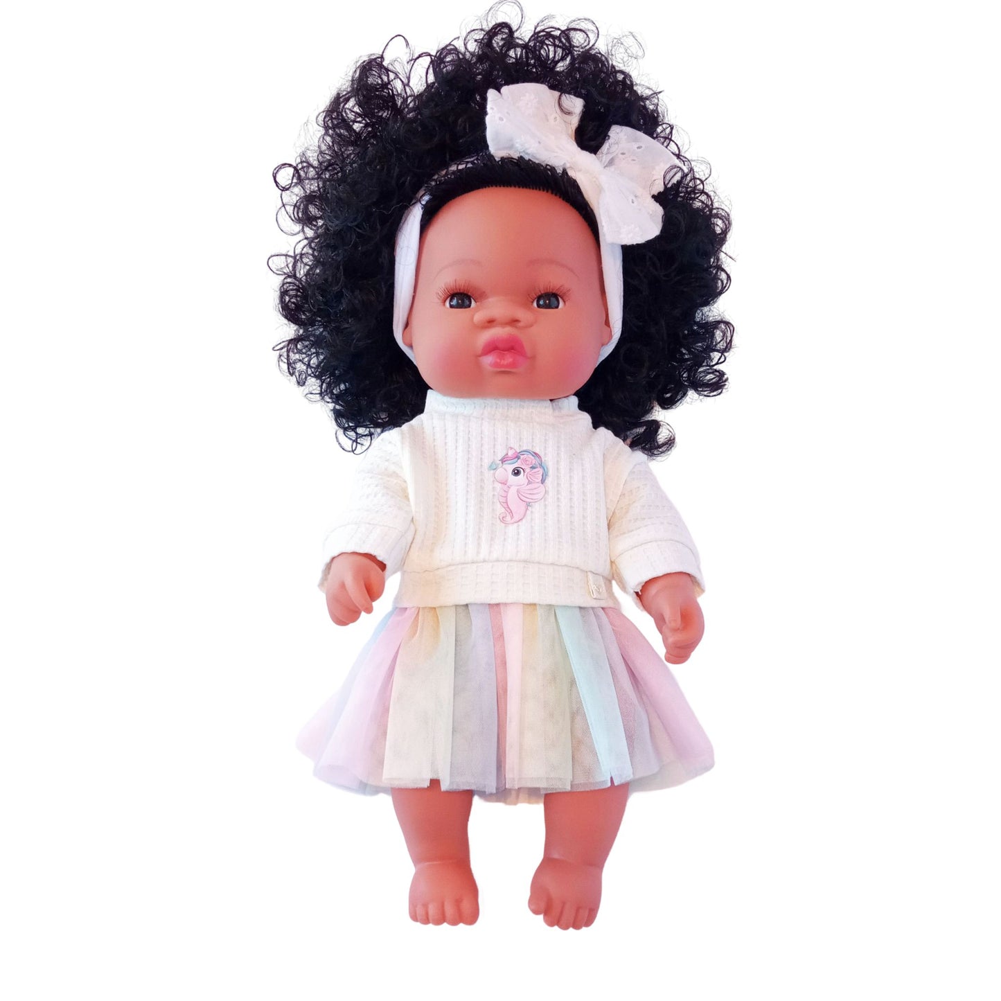 Doll wearing a pastel rainbow skirt and cream knit blouse with unicorn-seahorse print, styled for Paola Reina or Baby Born 34 cm dolls.