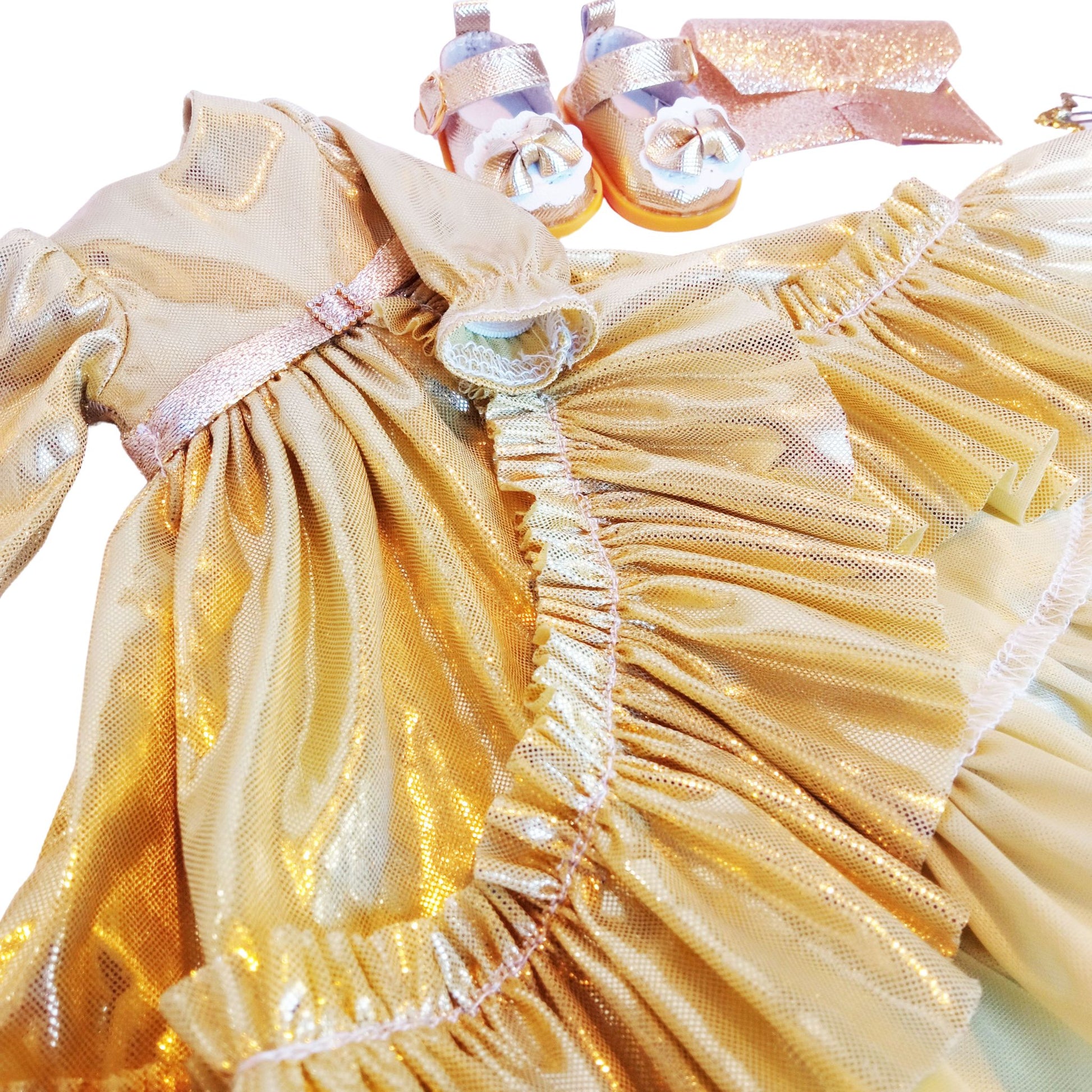 Dressed in an elegant shimmering gold gown with ruffles, holding a glittery clutch, and wearing stylish gold-trimmed shoes for Paola Reina 32 cm doll.