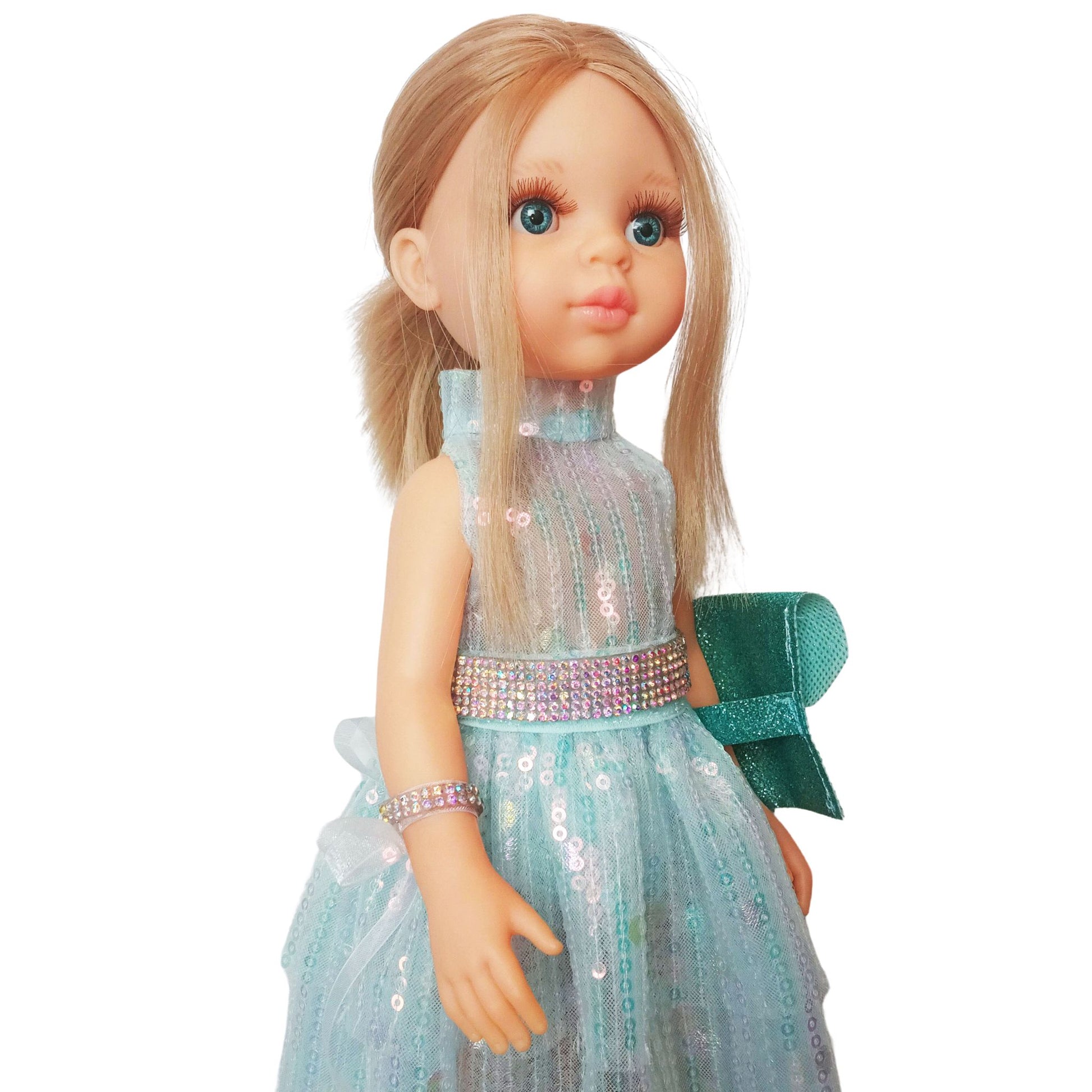Paola Reina 32 cm doll in a shimmering sequin fairy dress with a sparkling belt and clutch  standing on a floor.