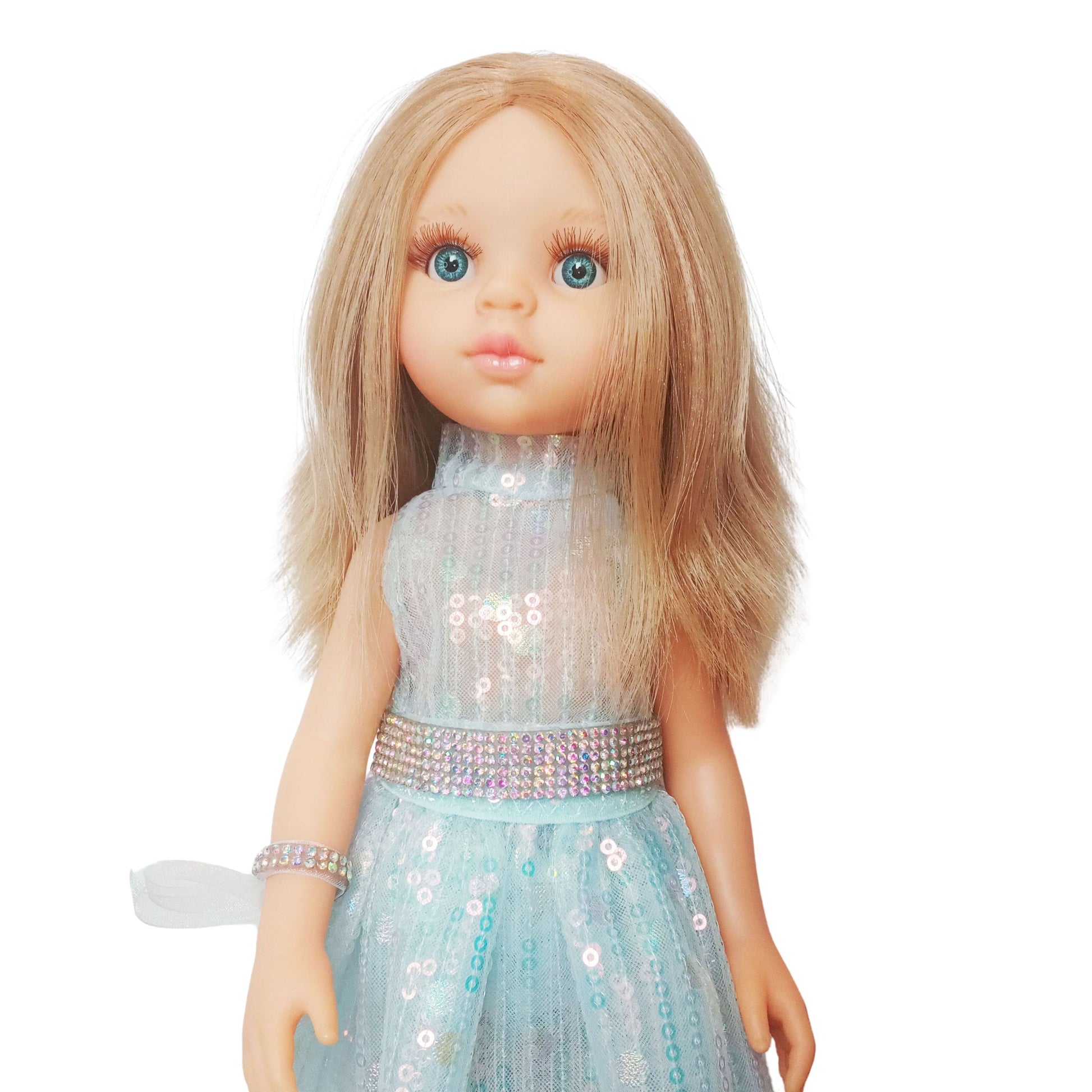 Paola Reina 32 cm doll in a shimmering sequin fairy dress with a sparkling belt and clutch  standing on a floor.