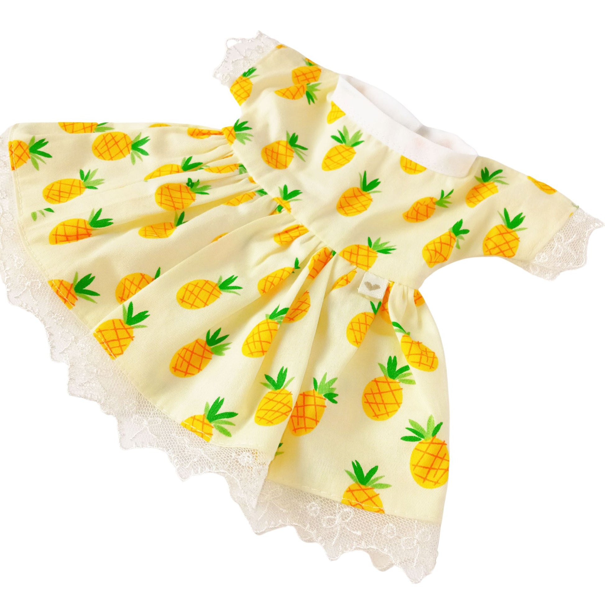 A yellow summer dress with pineapple print and lace hem, paired with a matching headband with bow, suitable for 34 cm dolls like Paola Reina or Baby Born