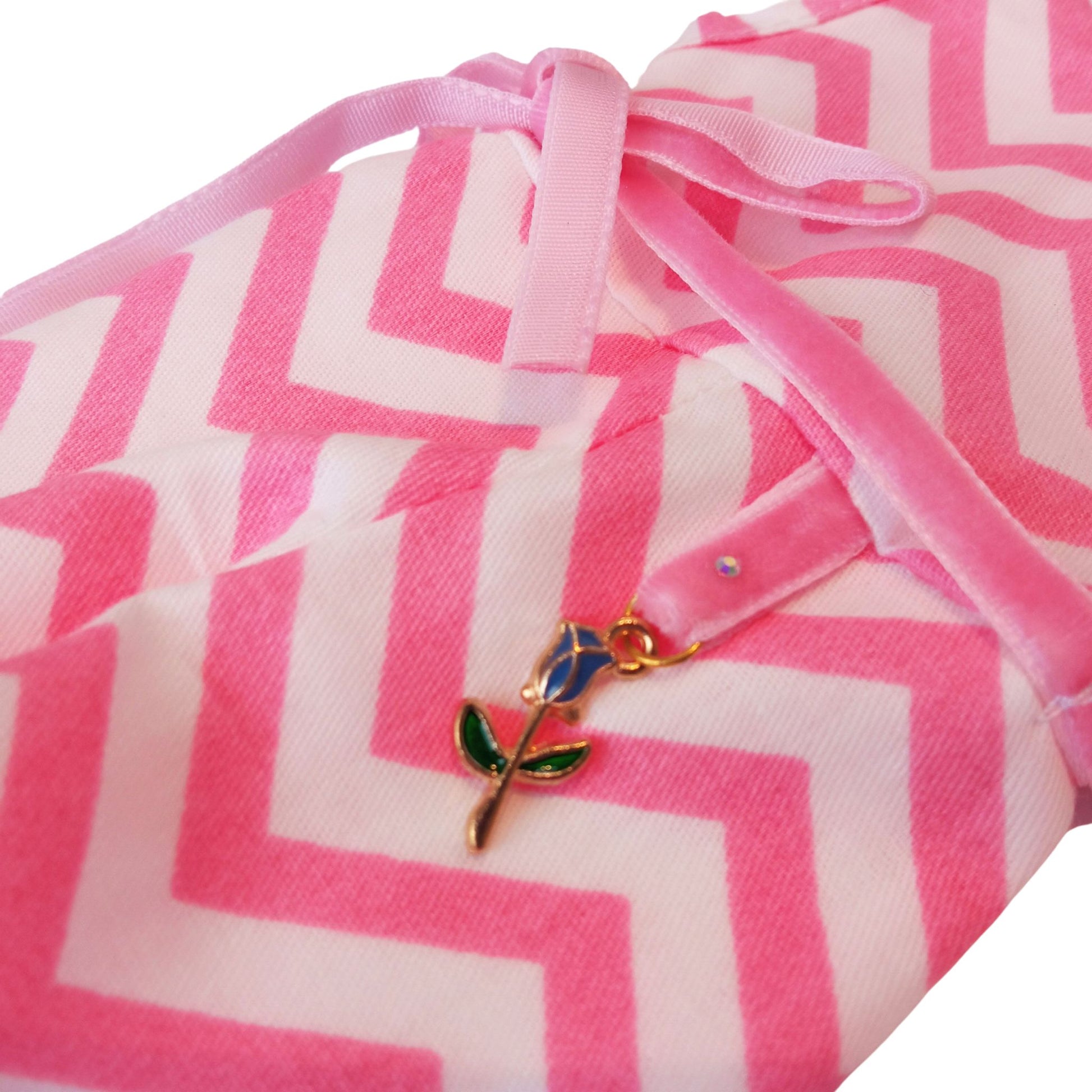 Wearing a pink and white zigzag summer jumpsuit with a ribbon belt and matching headband for doll Paola Reina 32 cm doll.