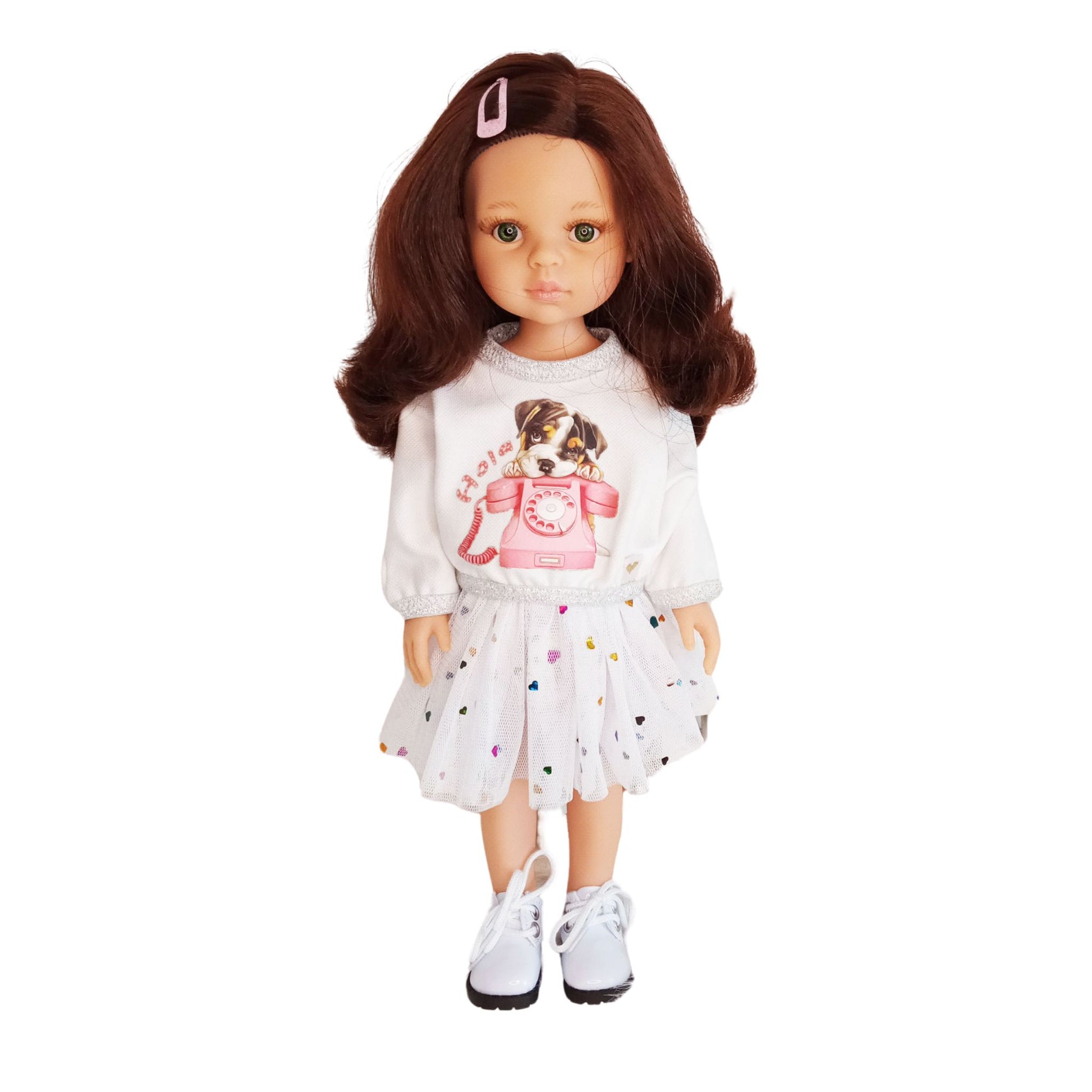 Paola Reina doll dressed in a white blouse with a puppy print and a mesh skirt decorated with colorful hearts.