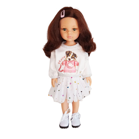 Paola Reina doll dressed in a white blouse with a puppy print and a mesh skirt decorated with colorful hearts.
