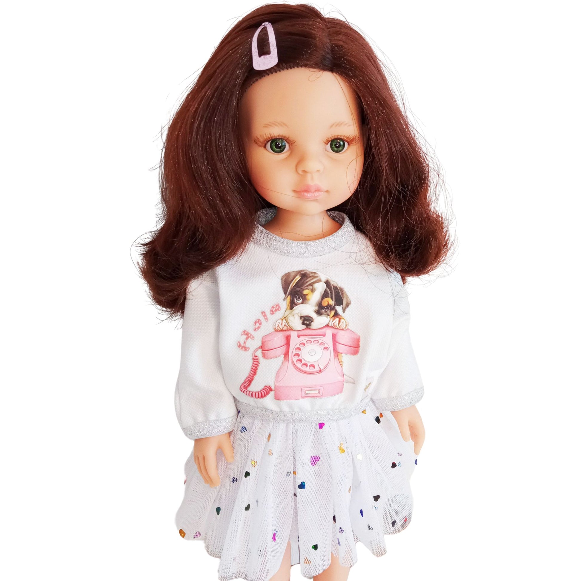 Paola Reina doll dressed in a white blouse with a puppy print and a mesh skirt decorated with colorful hearts.