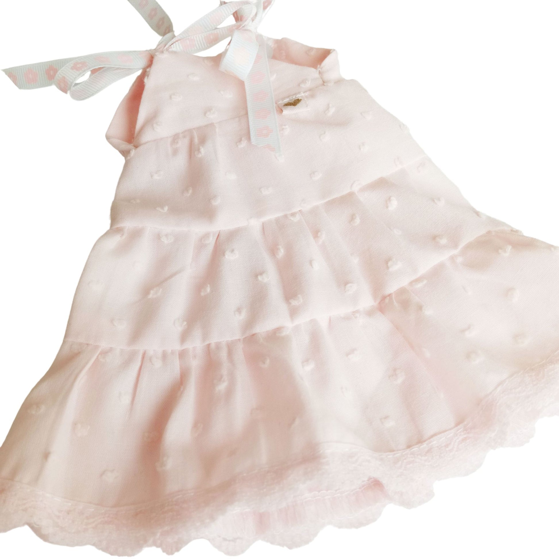 Soft pink sleeveless dress with lace trim perfect for playful adventures and tea parties.